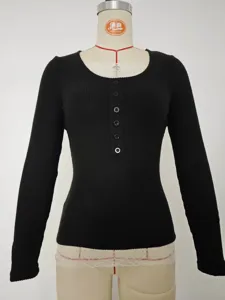 Black knit long sleeve top detail featuring front single-breasted buttons and delicate lace splice.