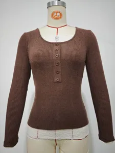 Detailed view of women ribbed knit long sleeve top with button placket and lace trim.