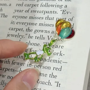 Cute cartoon frog enamel brooch pin featuring colorful balloons, exquisite metal alloy accessory.