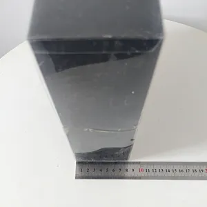 Detailed view of packaging box with measurement ruler, showing size and shape clearly.
