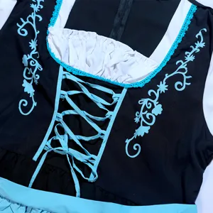 Close-up detail of traditional Bavarian costume bodice with blue lacing and lace trim.