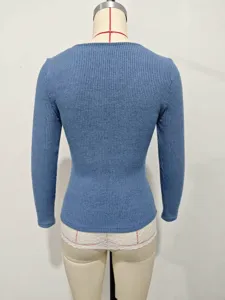 Detail view showing the back design of a blue ribbed long-sleeve knitted top for women.