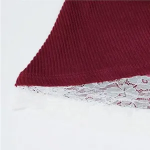 Close up view of womens burgundy ribbed knit top featuring delicate white lace hem trim.