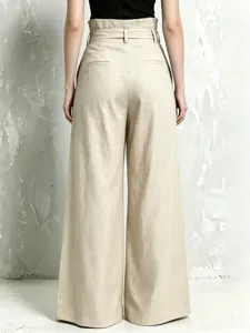 High waist linen blend wide leg trousers back view showing pleated paperbag waist and drape.