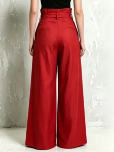 Back view of red high-waisted wide-leg trousers, featuring a belted paperbag waist design.