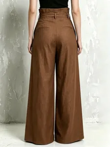 Back detail of brown high-waisted paperbag trousers featuring wide legs and waist belt.