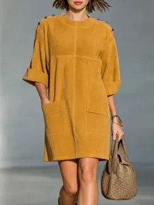 Detailed view of the vintage suede dress showcasing shoulder buttons and front pocket design.