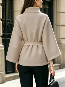 Detail shot of the elegant beige woolen coat with a stylish waist belt and chic collar design.