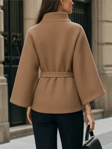 Detail view of the stylish camel woolen coat back, featuring a chic belted waist and wide sleeves.