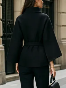 Back view detail of a solid color long sleeve waist-tied woolen coat in classic black.