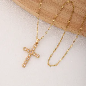 Gold cross pendant necklace featuring sparkling cubic zirconia stones, elegant design.
