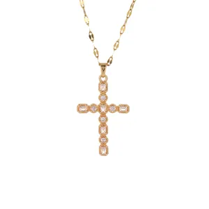 Gold cross pendant necklace featuring baguette and round cubic zirconia with delicate beaded details.