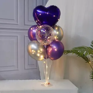 Birthday purple heart balloon table stand set for kids party celebration and romantic decor.