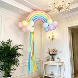 Pastel rainbow balloon arch kit with long ribbons for kids birthday party and event decoration.