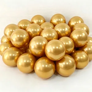 Metallic gold party balloons cluster detail, shiny round latex balloons for birthday decoration.