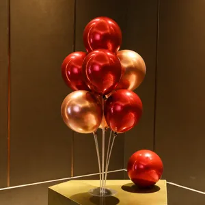 Red and rose gold balloon table centerpiece set detail view with clear stand and pump
