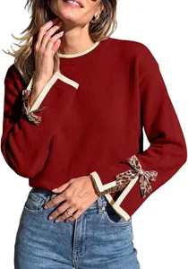Red women's knit sweater detail showing contrast ribbed trim and cute leopard print bow accent cuffs.