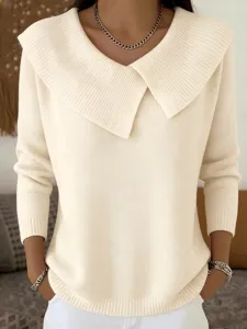 Close-up view of the cream wide-lapel knit sweater, featuring ribbed details and cozy fit.