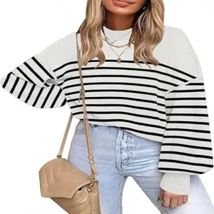 Close-up detail of the black and white striped balloon sleeve knitted sweater texture.