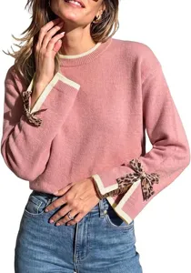 Pink knit sweater featuring contrast cream ribbed cuffs and stylish leopard print bow sleeve details.