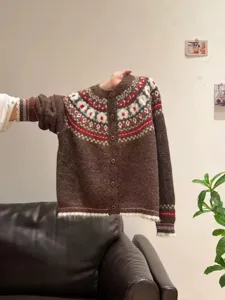 Detailed view of the brown knit cardigan showing ethnic jacquard patterns and buttons.