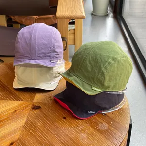 Close-up detail of lightweight quick-drying kids sun caps, double-sided wearable outdoor hats.
