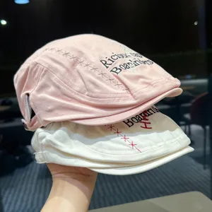 Detailed shot of kids stylish embroidered flat cap, soft cotton material, casual outdoor look.