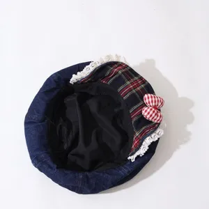 Detailed view of children denim beret featuring cute plaid patch and delicate lace trim.