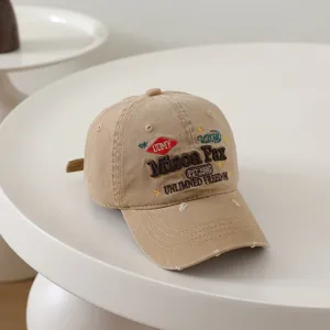 Close-up detail of vintage washed cotton baseball cap with retro embroidery design.