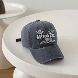 Close-up detail shot of vintage washed distressed embroidered baseball cap with unique letters.