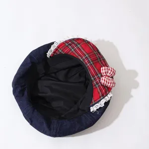 Children denim beret detail showcasing red plaid patch, white lace trim and cute bow design.