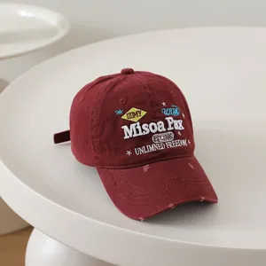 Vintage embroidered baseball cap in burgundy, soft top casual sun hat with cool letters.