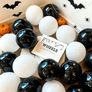 Halloween party decoration set with black and white balloons, pumpkins and bat stickers for events.