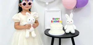 Birthday party decoration set with cute plush rabbit toys, balloons and birthday cake.