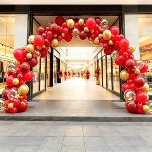 Detailed view of the grand red and gold balloon arch setup for grand opening and celebrations.