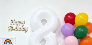 Details of 40-inch white number 8 foil balloon with colorful party balloons for birthday setup.