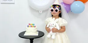 Birthday party scene decoration details featuring cute girl with balloon props and cake.