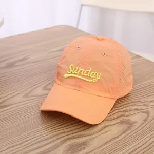 Detailed view of the orange breathable quick-dry baseball cap featuring clear front embroidery.