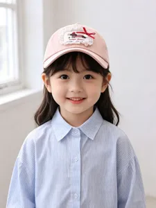 Detail shot of cute kids pink baseball cap with lace patch and lovely puppy embroidery design.