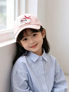 Cute kids pink baseball cap detail, featuring a sweet bow and lace patch, perfect for outdoor sunny days.