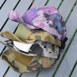 Detailed view of colorful camouflage 5-panel camp hats, quick-dry fabric, outdoor style.