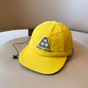 Detailed close-up of children's yellow quick-drying baseball cap with embroidery and strap.