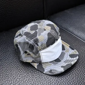Camo 5-panel kids cap detail view, featuring quick-dry grid fabric and short brim design.