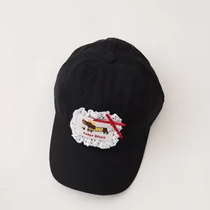 Kids black baseball cap featuring cute dachshund patch, lace trim and bow for outdoor sun days.