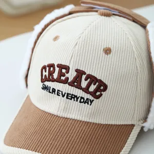 Kids corduroy winter baseball cap with warm earflaps and stylish letter embroidery details.