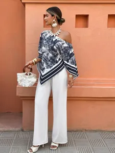 Detailed view of the stylish blue and white printed one-shoulder irregular sleeve top.