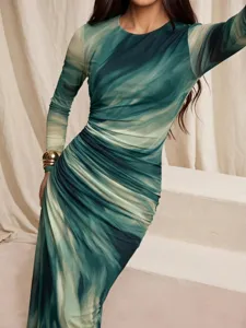 Close-up detail of women's long sleeve marble print ruched dress in elegant green style.
