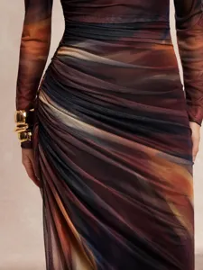 Close-up view of the stylish marble print long sleeve dress featuring mesh fabric.