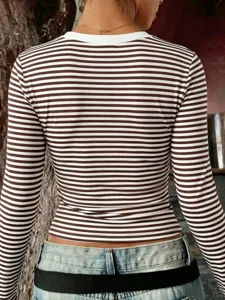 Detailed view of a slim-fit brown and white striped long-sleeve top showcasing its texture.