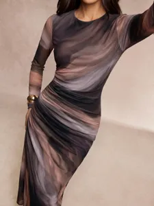 Close-up detail of women's abstract marble print long-sleeve maxi dress, elegant style.